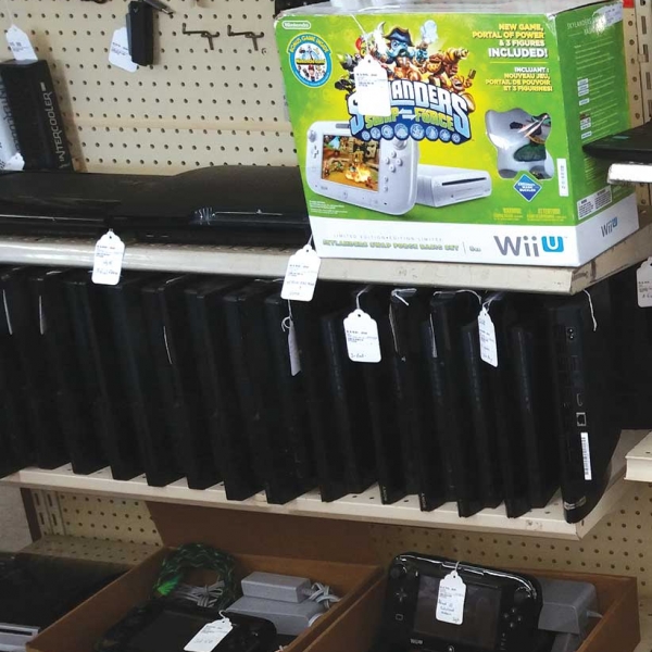 video game consoles for sale on a shelf