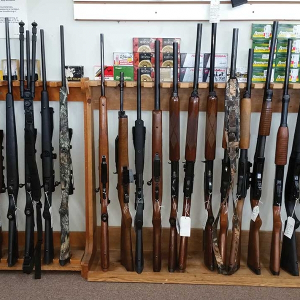shotguns and rifles for sale on display